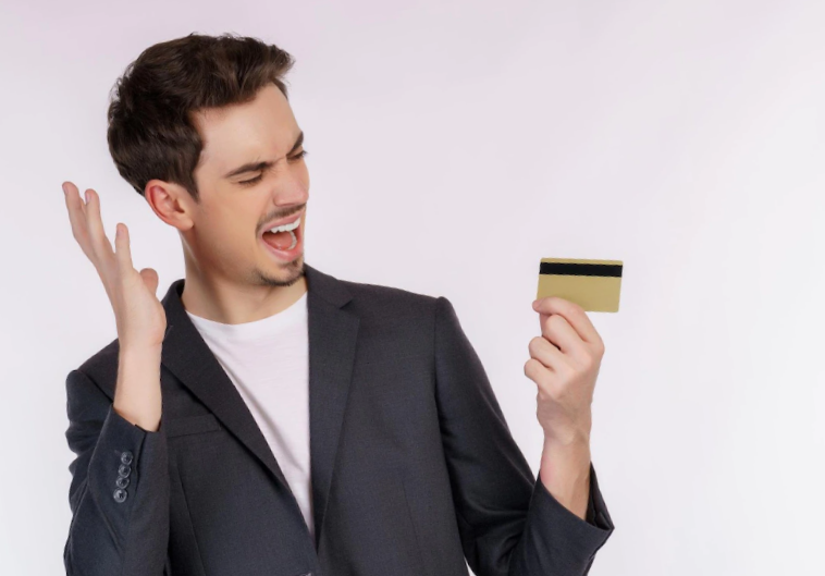 Photo portrait of unhappy businessman showing credit card isolated over white background