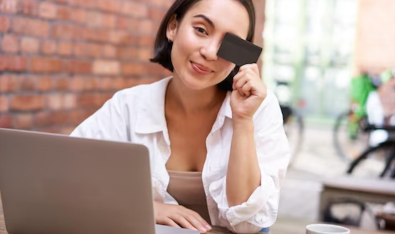 photo happy young asian female sitting with laptop and showing credit card paying bills online shopping in
