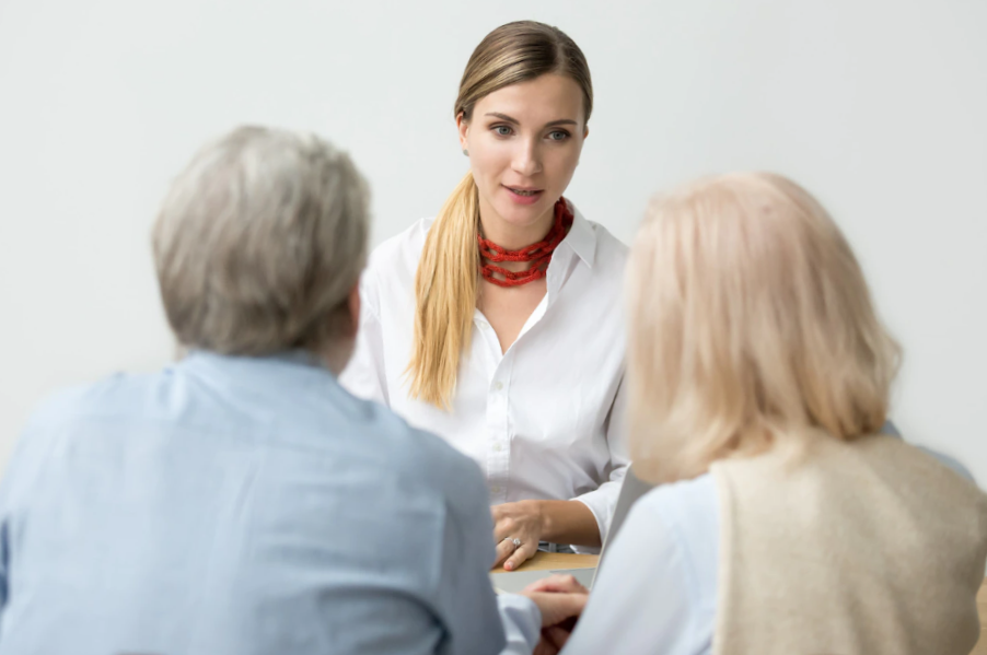 Female financial advisor talking to a senior aged couple
